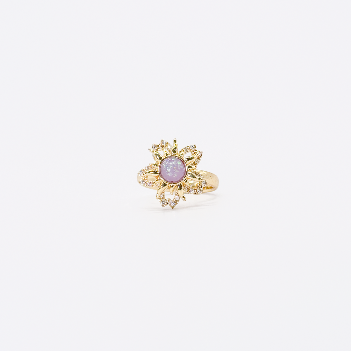 Anillo dorado de chapa de oro con diseño de sol, zirconias y centro violeta giratorio