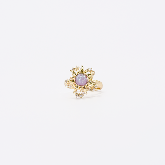Anillo dorado de chapa de oro con diseño de sol, zirconias y centro violeta giratorio
